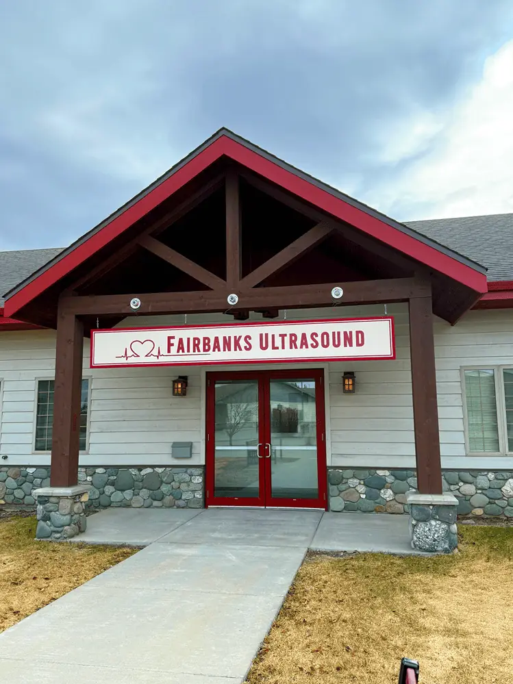Fairbanks Ultrasound sign above the red front doors of the clinic