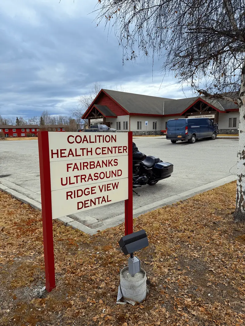 Roadside sign on Riverstone Way listing Coalition Health Center, Fairbanks Ultrasound and Ridge View Dental